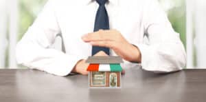 Suited man with block home
